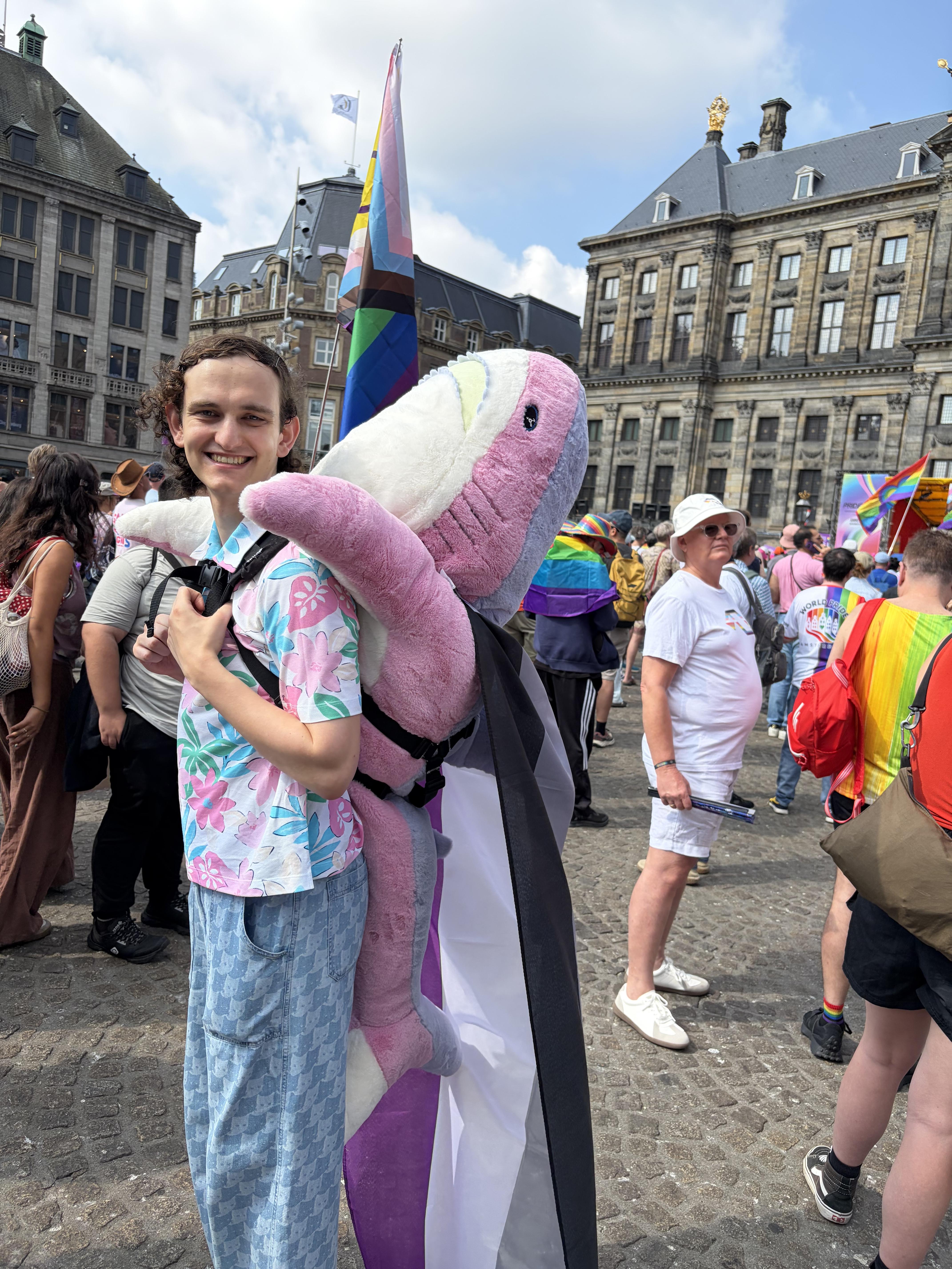 a cute person with a trans pride BLÅHAJ in Dams Square Amsterdam