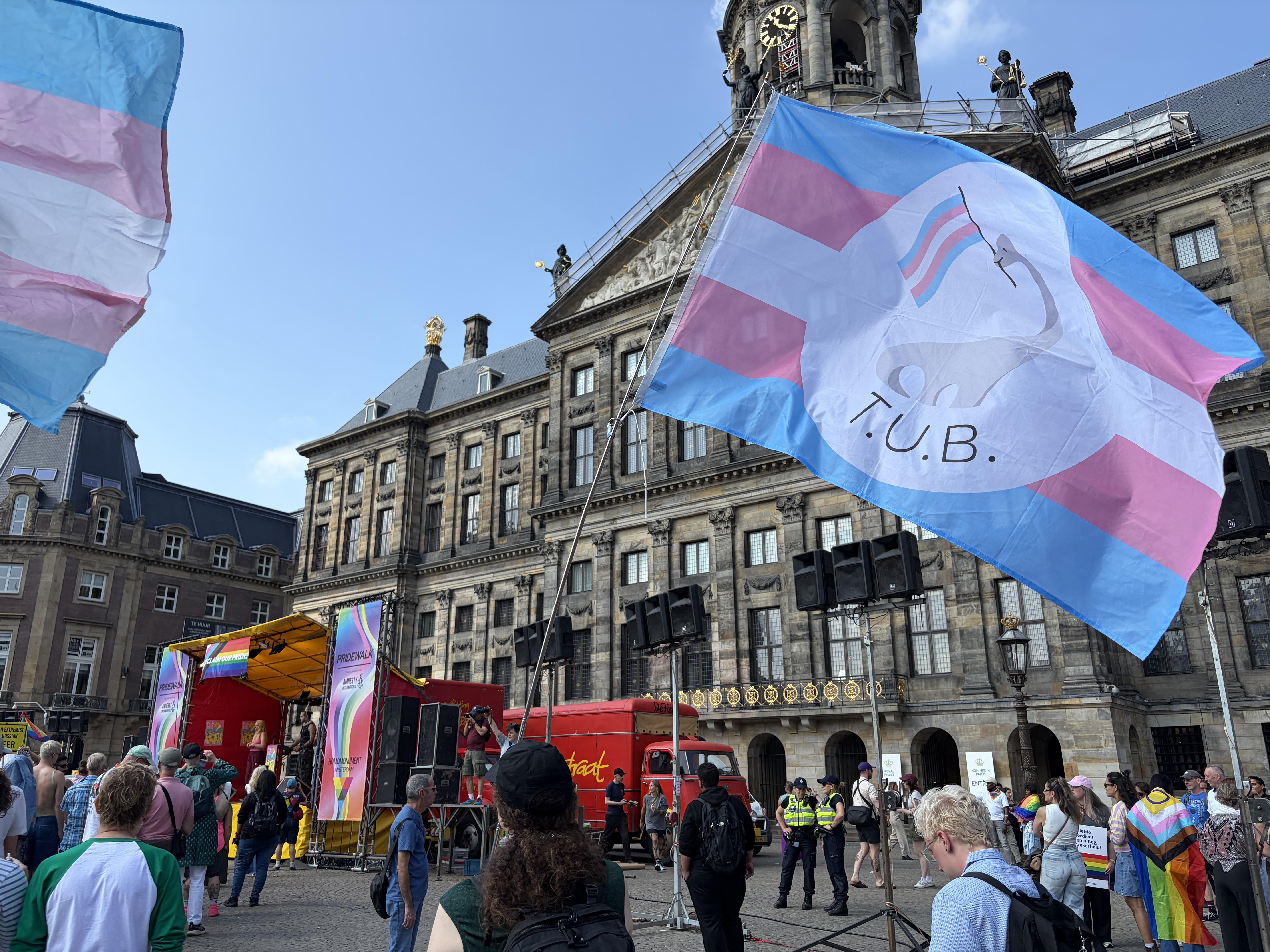 TUB trans pride flag waves in front of Royal Palace Amsterdam