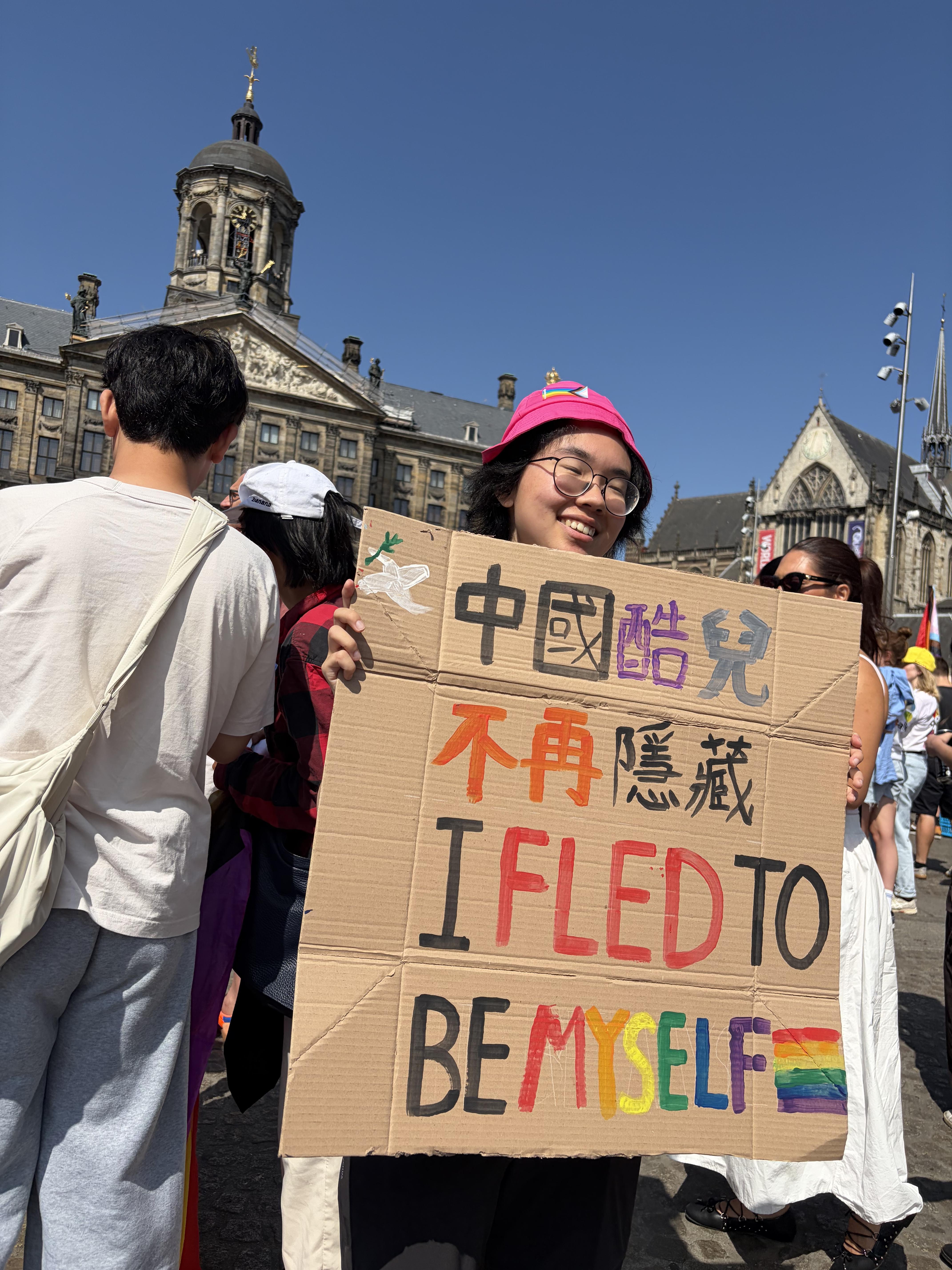 "i fled to be myself" sign in Dams Square Amsterdam