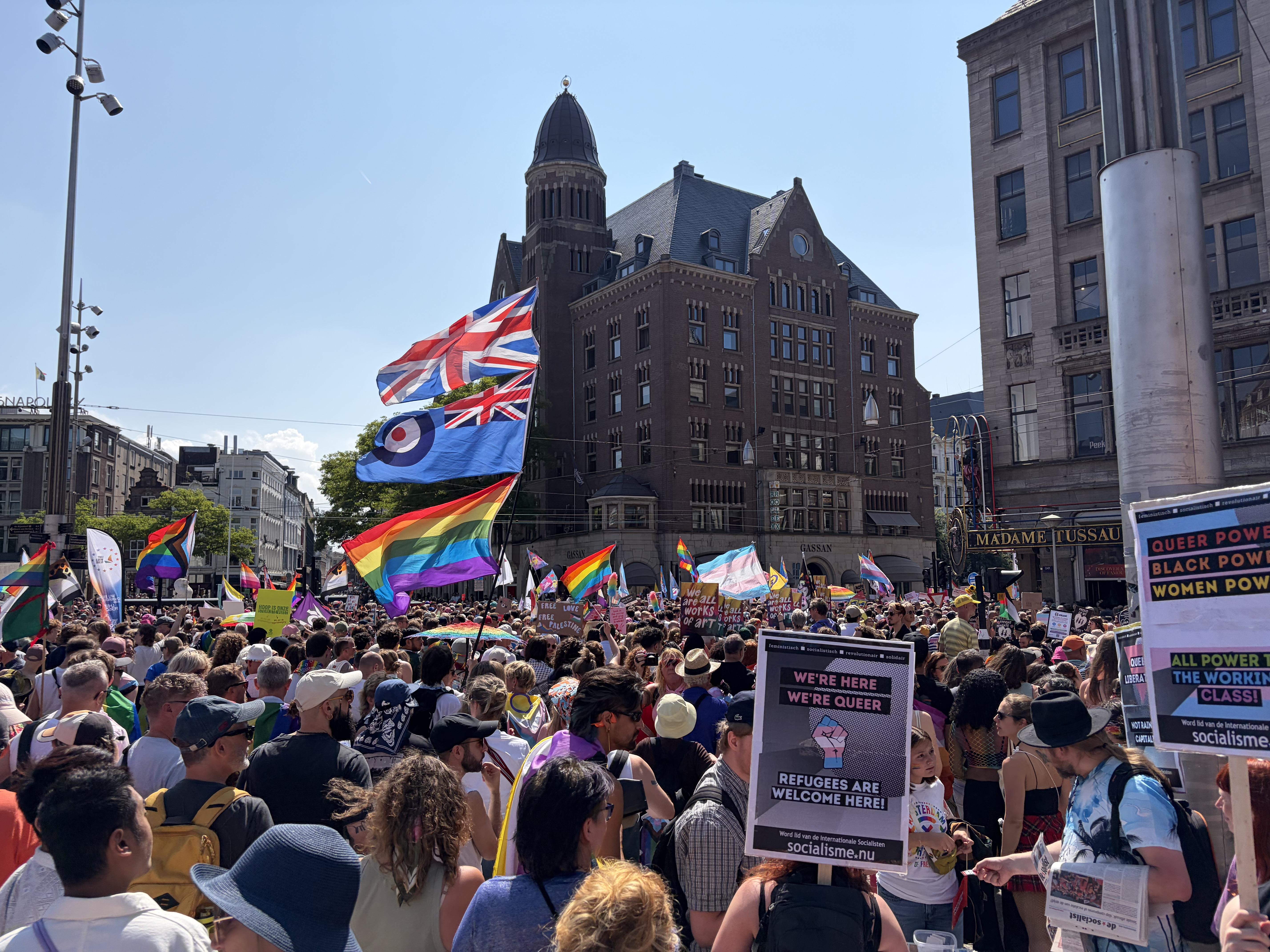 a large crowd gathers in Dams Square for the Pride Walk